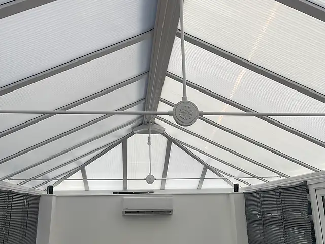 Domestic air conditioning in West London A wall-mounted air conditioner inside a conservatory with a glazed roof, the kind of air conditioning we fit for homes in West London
