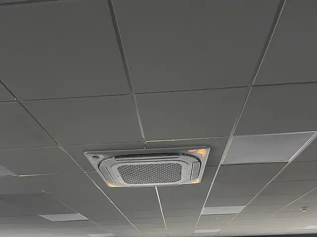 A four-way ceiling cassette in a suspended office ceiling, the kind of commercial air conditioning we fit for businesses in Kingston upon Thames
