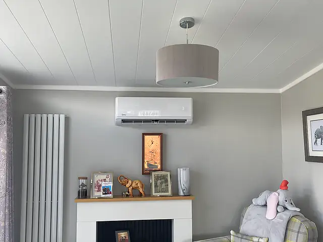 Domestic air conditioning in South London A split air conditioning unit above a living room fireplace, the kind of air conditioning we fit for homes in South London