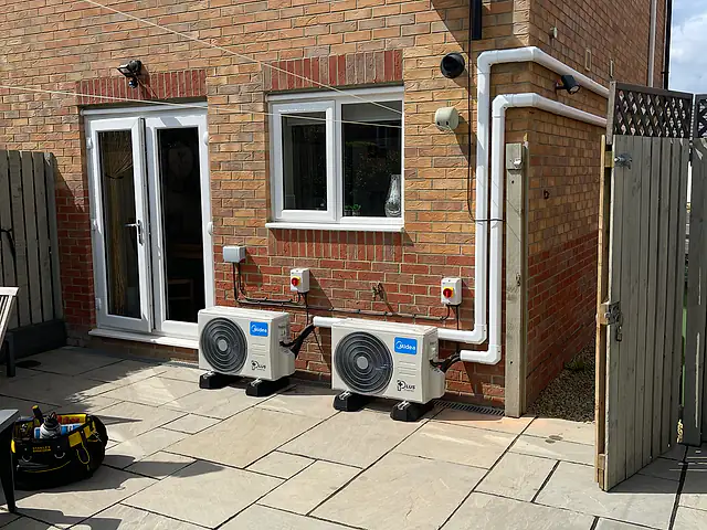 Domestic air conditioning in Holborn Two outdoor air conditioning units on a patio with neat trunking, the kind of air conditioning we fit for homes in Holborn