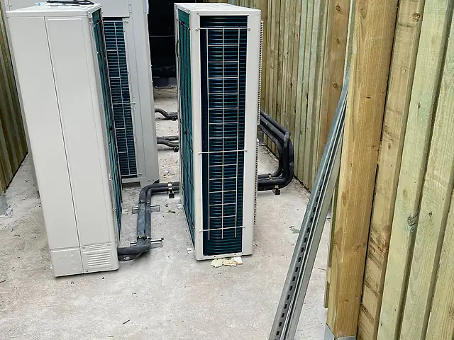 Large commercial outdoor air conditioning units in a plant area, the kind of commercial air conditioning we fit for businesses in Tower Hamlets