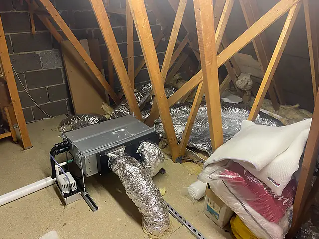 Ducted air conditioning in a loft, London Concealed ducted air conditioning unit installed in a loft space with insulated flexible ducting