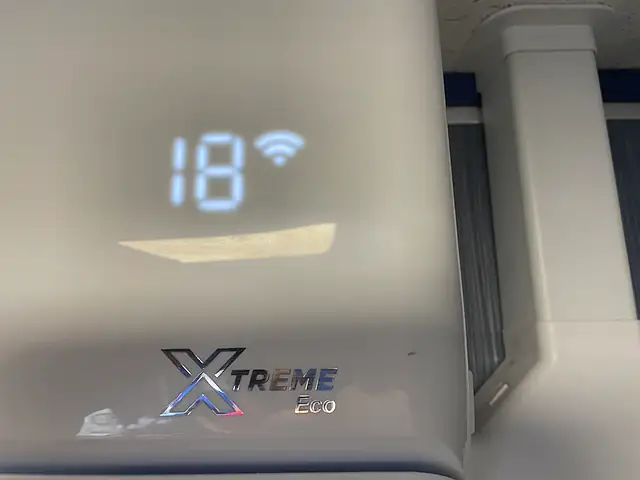 Air Conditioning Servicing in London Air Conditioning Servicing in London: an air conditioning unit display showing the set temperature and Wi-Fi